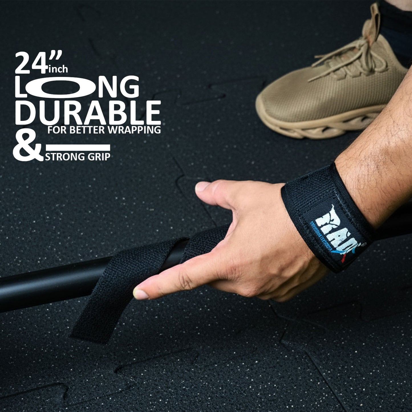 Hand wearing a wrist Strap with text about durability and grip on a black surface.