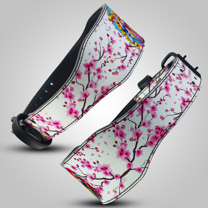 Two Weightlifting Belts with cherry blossom design on a gray background